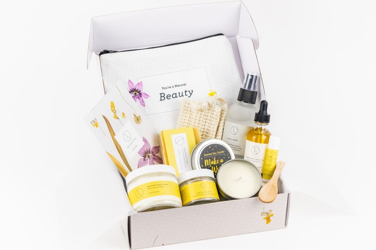Natural citrus spa gift box featuring soap, body oil, scrub, clay mask, and soy candle
