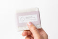 Two natural handmade lavender soap bars with real buds packed in a reusable cotton bag.