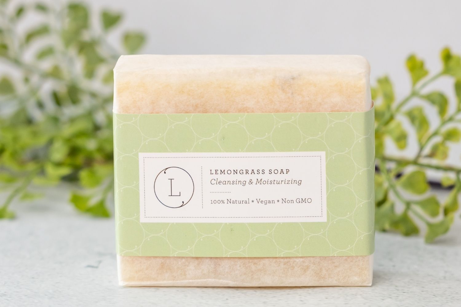 Two natural cold process essential oil soap bars resting inside a reusable cotton drawstring bag — view 3