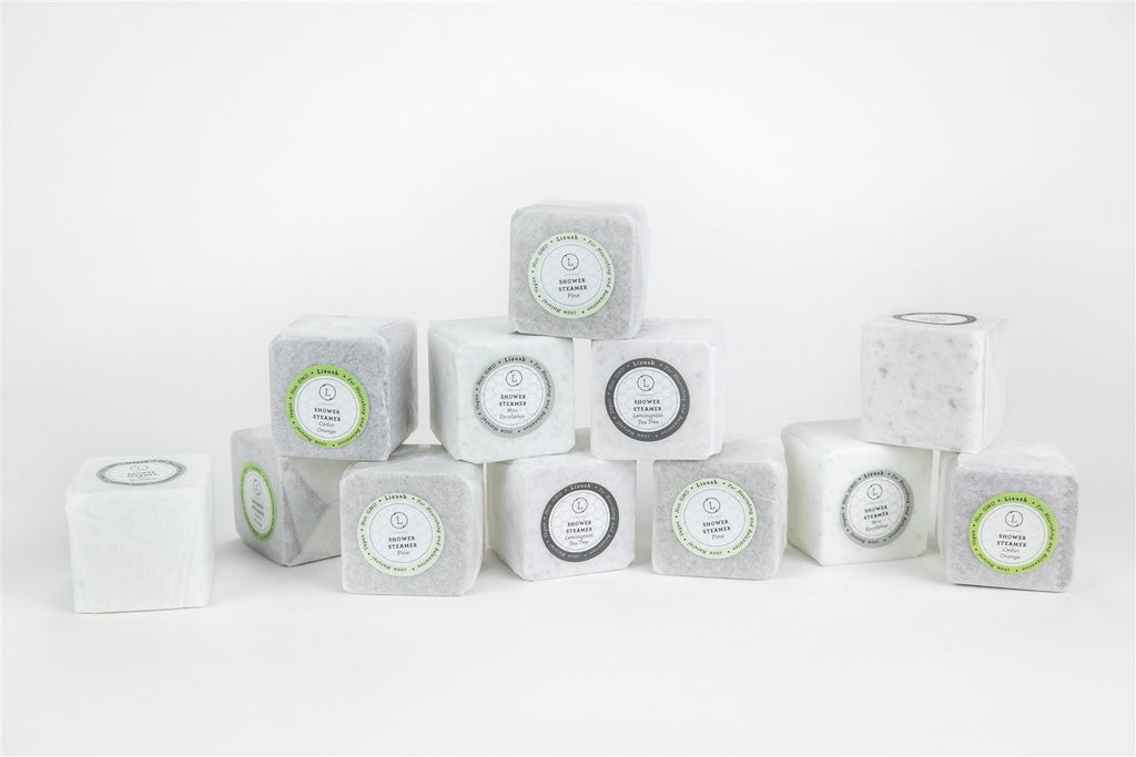 Set of 12 earthy shower steamers in a premium gift box with natural botanical tops — view 4