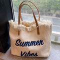 Large woven canvas tote bag for women featuring embroidered letters and sturdy shoulder carry straps