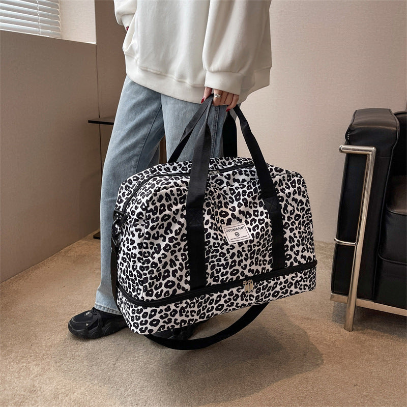 Versatile women's weekender gym and yoga travel bag with spacious compartments and sturdy carrying handles.