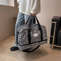 Versatile women's weekender gym and yoga travel bag with spacious compartments and sturdy carrying handles.