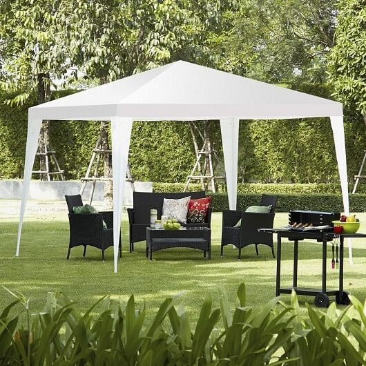 White 10x10 outdoor wedding canopy tent set up in a backyard with steel framework — view 2