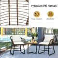 White 3-piece patio rattan bistro set with two cushioned armchairs and a square glass side table
