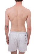 White men's swim shorts with elastic waistband, drawstring, and signature embroidered flag detail on front