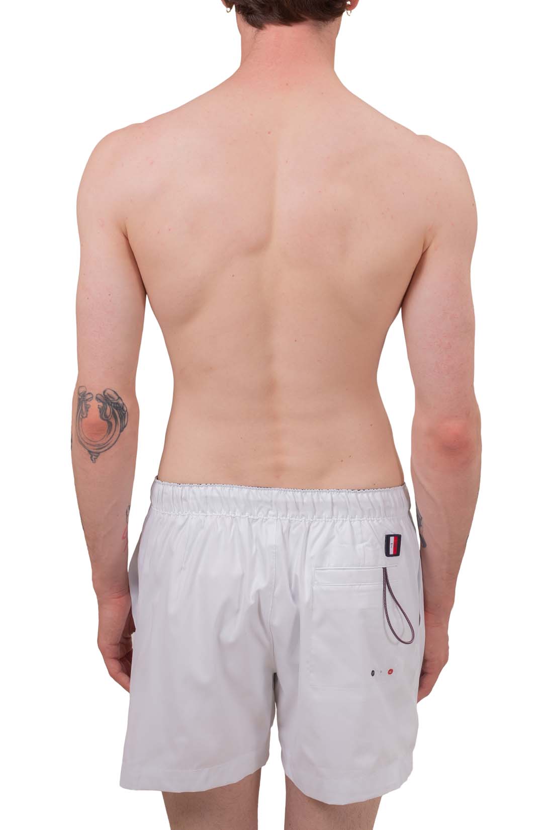 White men's swim shorts with elastic waistband, drawstring, and signature embroidered flag detail on front — view 4