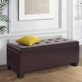 Brown faux leather storage ottoman blanket box with wooden legs and lift-up cushioned lid.