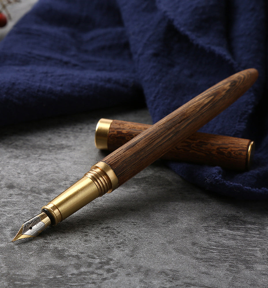 Handcrafted solid wood and brass fountain pen with a fine iridium nib on a desk — view 5