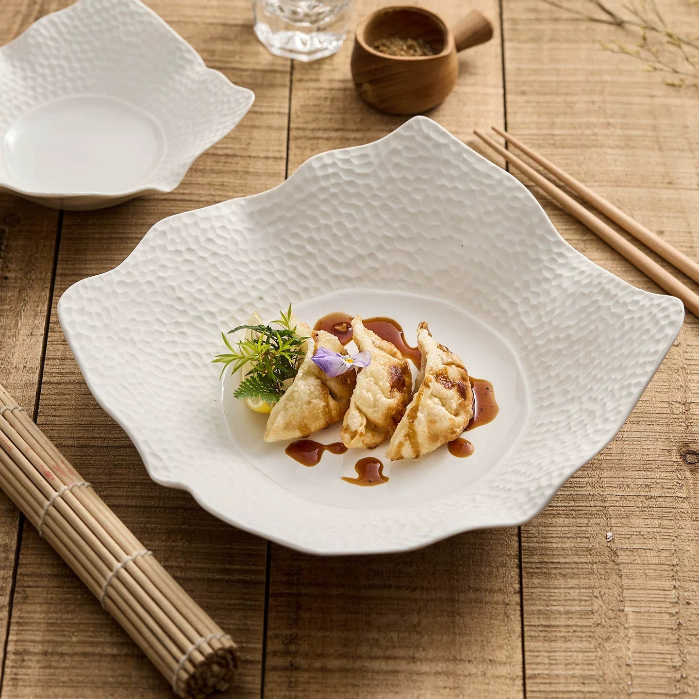 Irregular matte square plate in off white high fired ceramic with lattice surface