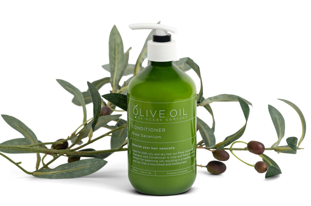Rose geranium hair conditioner in a 500ml pump bottle with natural olive oil botanical branding.