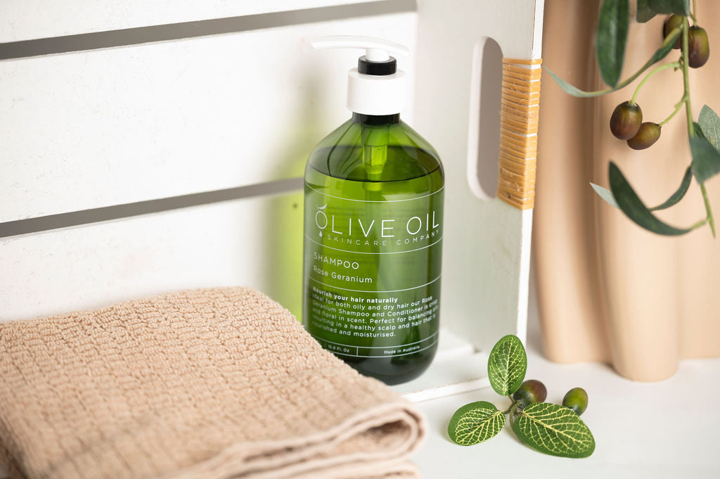 Rose geranium hair conditioner in a 500ml pump bottle with natural olive oil botanical branding. — view 2