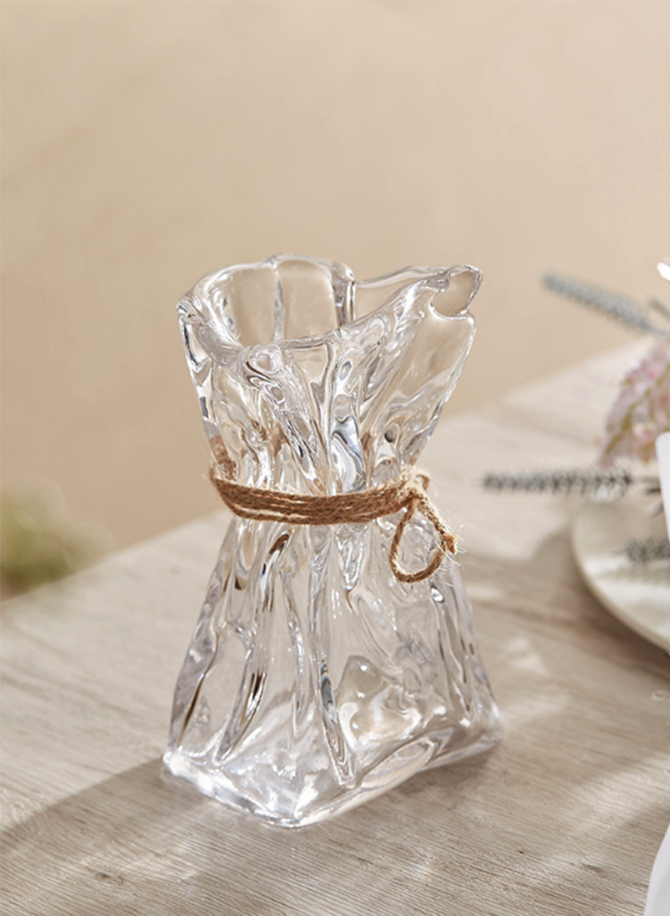Wrinkled glass vase with natural twine accent and folded paper texture on a modern table — view 5