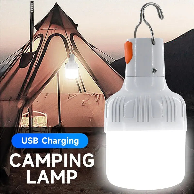 Rechargeable LED outdoor camping lantern bulb emitting bright white light alongside a USB charging cable — view 2