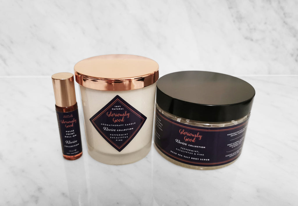 Revive aromatherapy gift set featuring organic essential oil body scrub, natural soy candle, and roll-on.