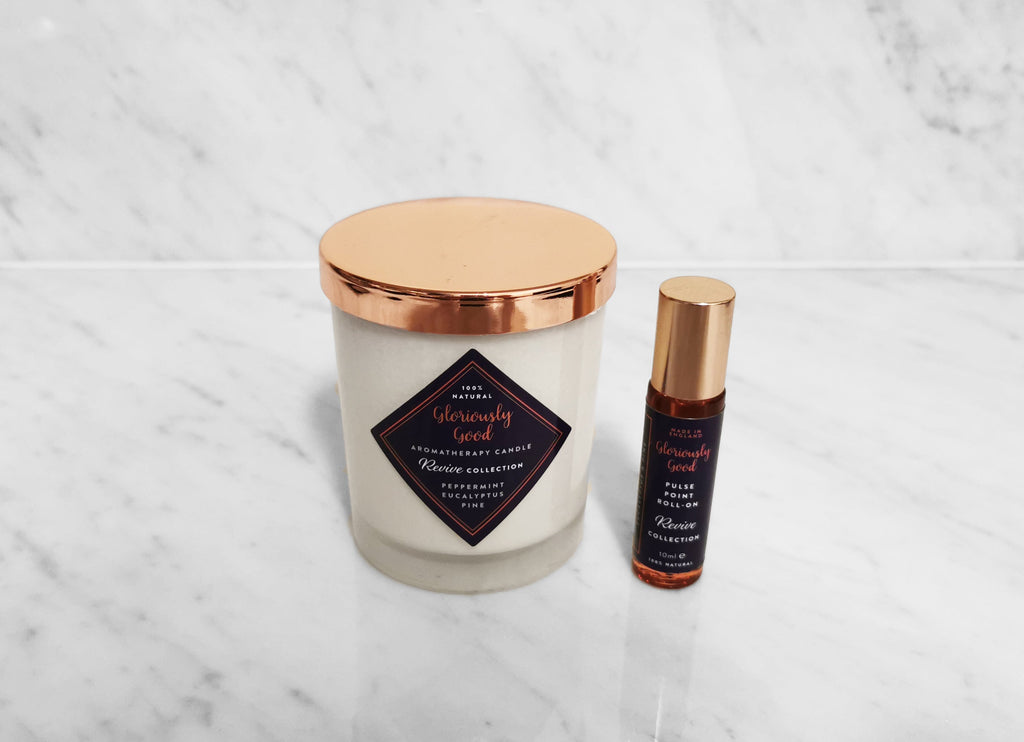 Uplifting aromatherapy gift set featuring a natural soy wax candle and glass roll-on oil bottle
