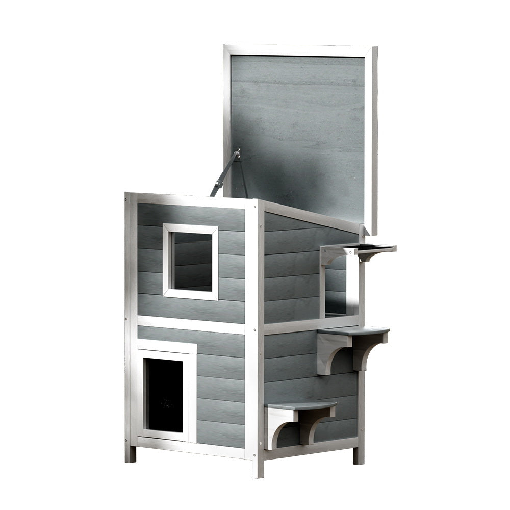 Grey and white two-tier wooden outdoor cat house with asphalt roof and viewing windows