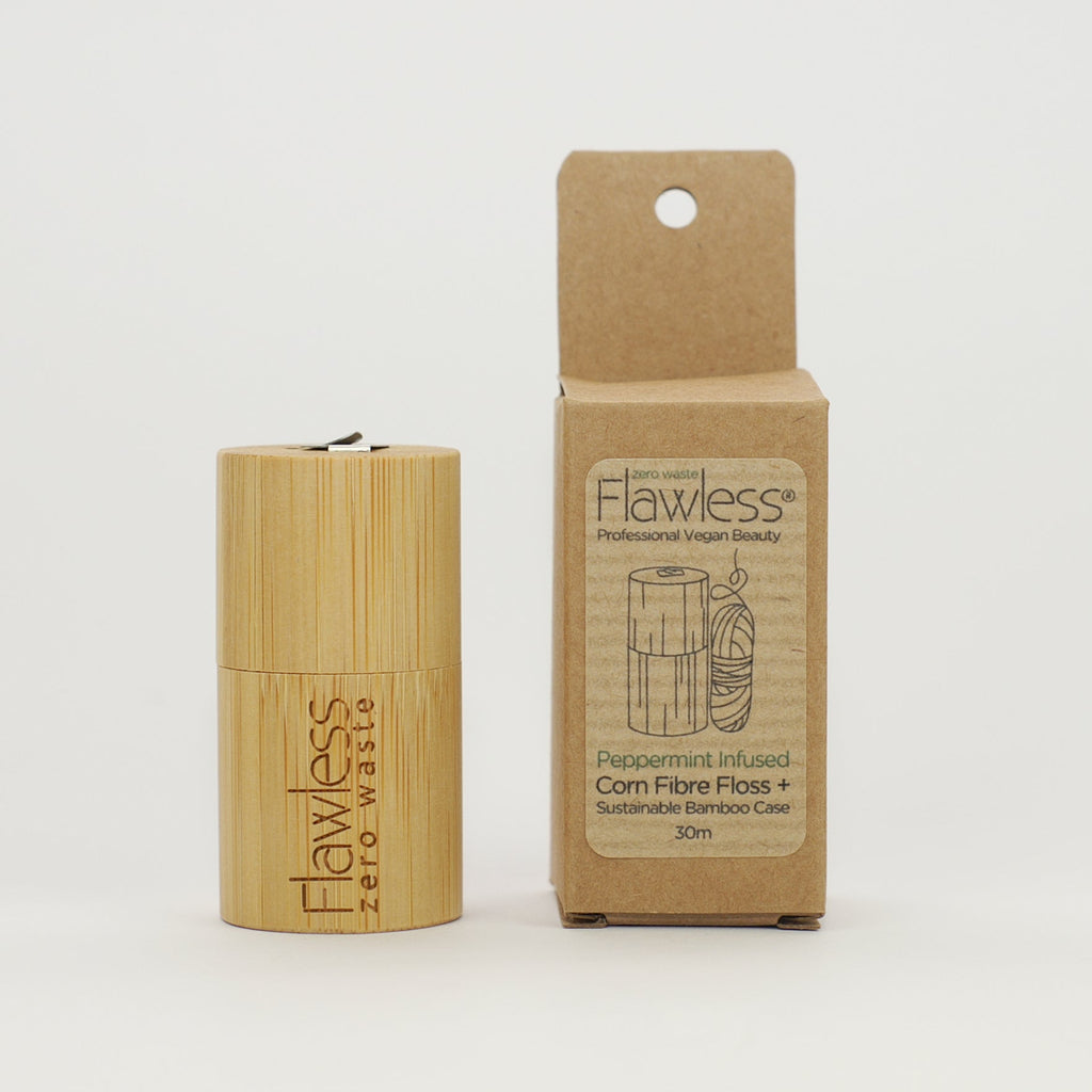 Compostable peppermint dental floss in a reusable natural bamboo cylindrical dispenser — view 2