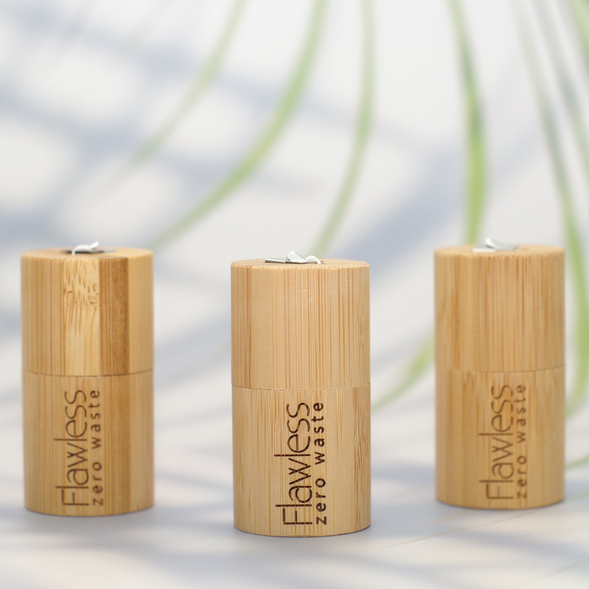 Compostable peppermint dental floss in a reusable natural bamboo cylindrical dispenser — view 3