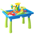 Multicolor kids sand and water play table with rotating windmill, water slide, and toy shovels.