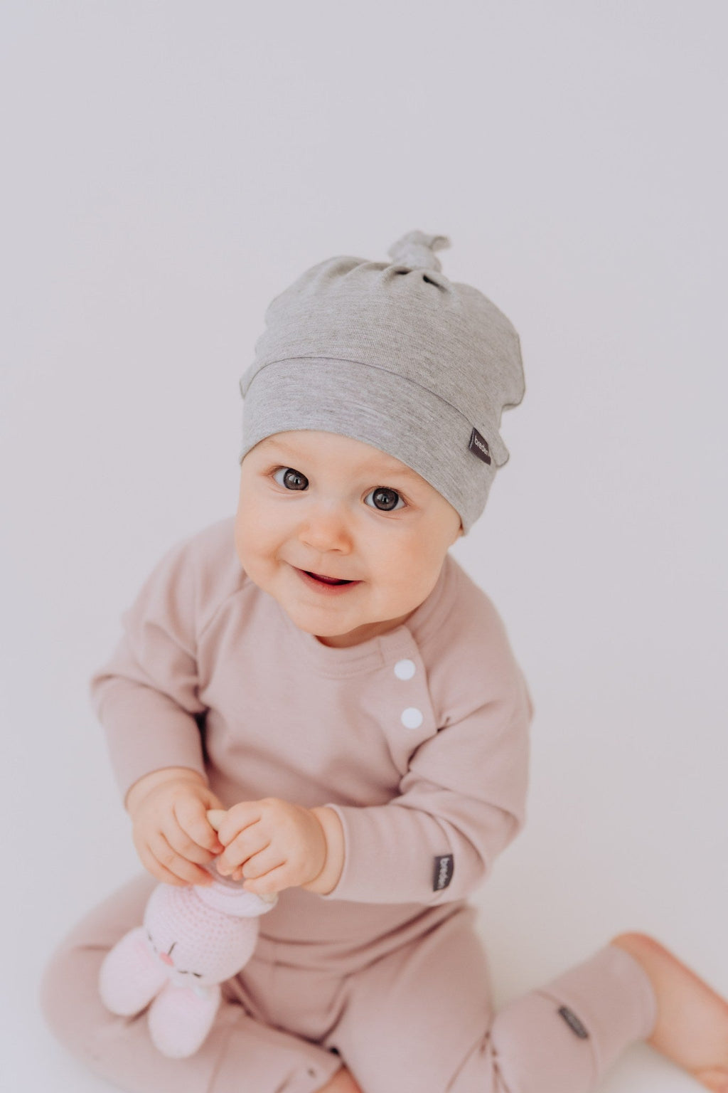 Bamboo viscose baby hat in soft fabric with adjustable top knot for newborn comfort and protection