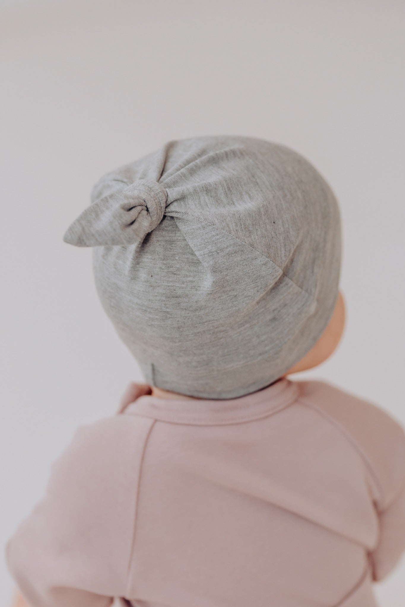 Bamboo viscose baby hat in soft fabric with adjustable top knot for newborn comfort and protection — view 3