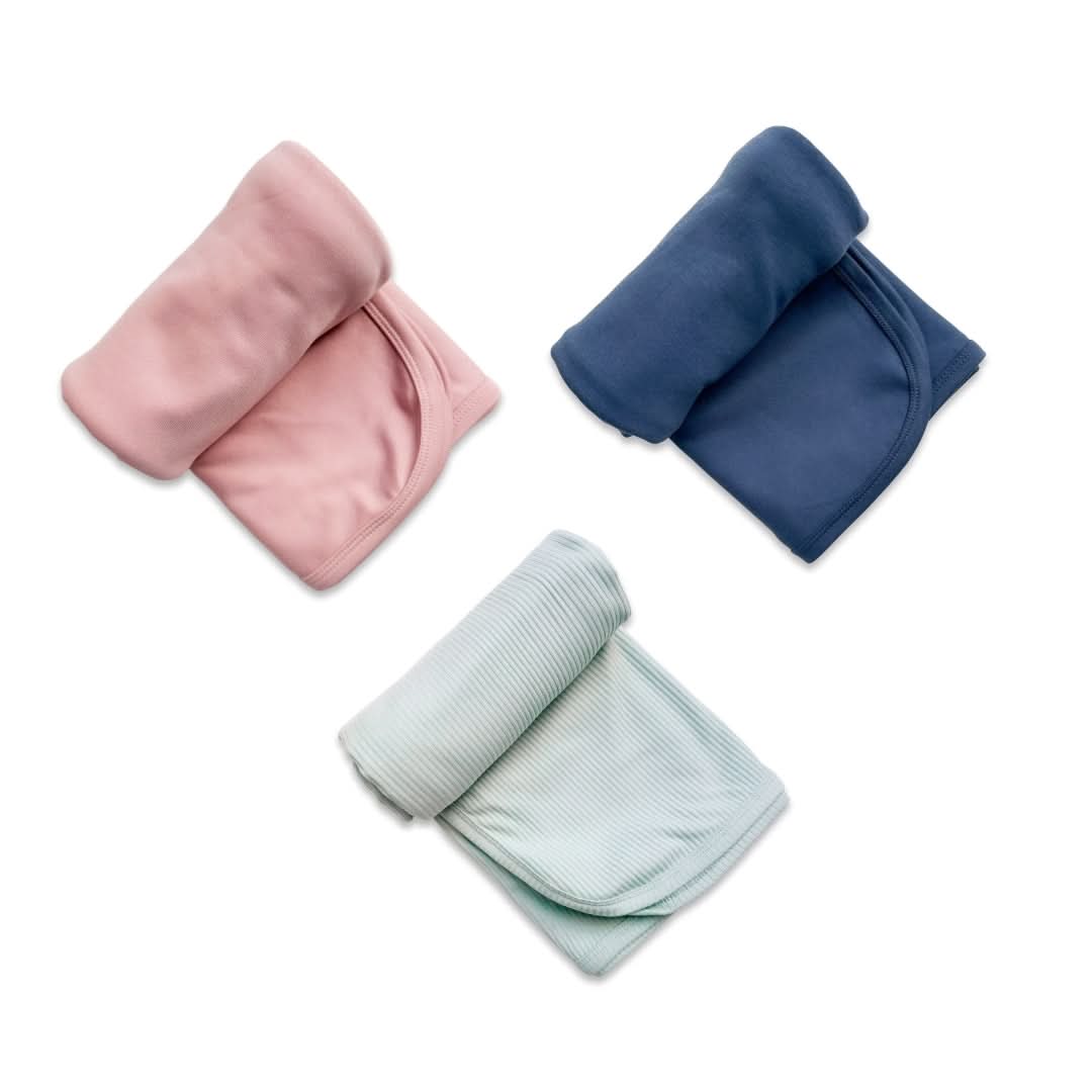 Baby bamboo swaddle blanket in solid rosewood pink folded to show the soft breathable knit fabric — view 2