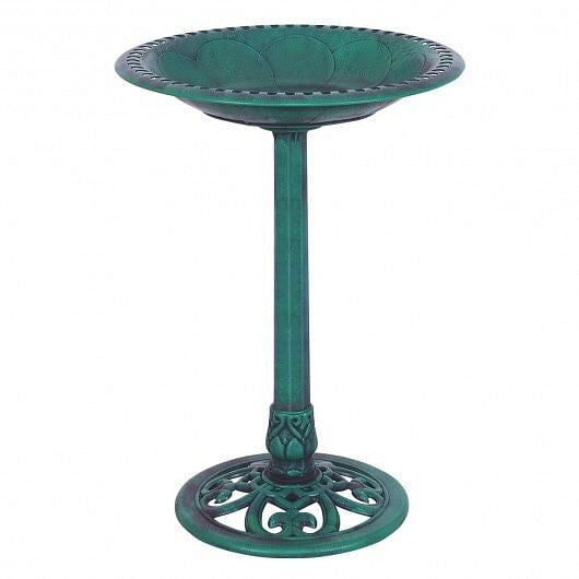 Green resin pedestal bird bath with copper verdigris effect on outdoor garden lawn