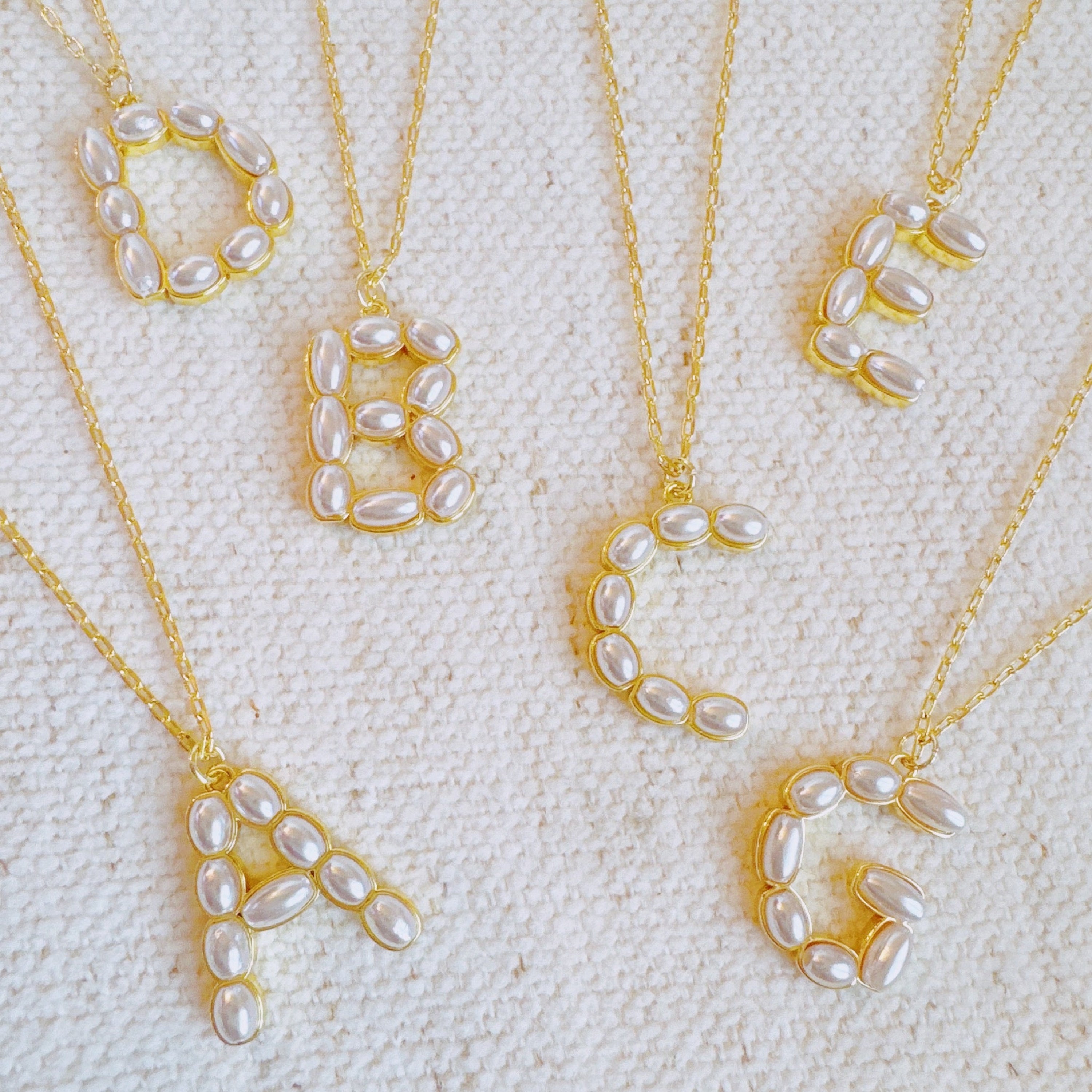 Pearl mosaic initial pendant necklace in 18k gold-plated brass with delicate pearl accents on chain — view 4