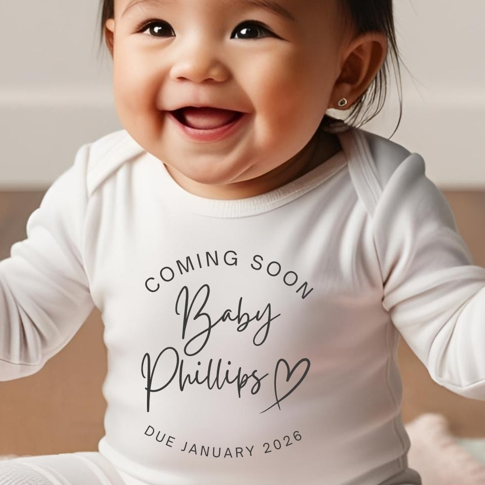 Personalised coming soon baby outfit in white with custom name and due date printed on front — view 3