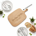 Personalized chopping board made of natural wood in an irregular shape with custom text engraving.