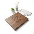Personalized walnut wood cutting board with custom engraving used for kitchen prep and serving food