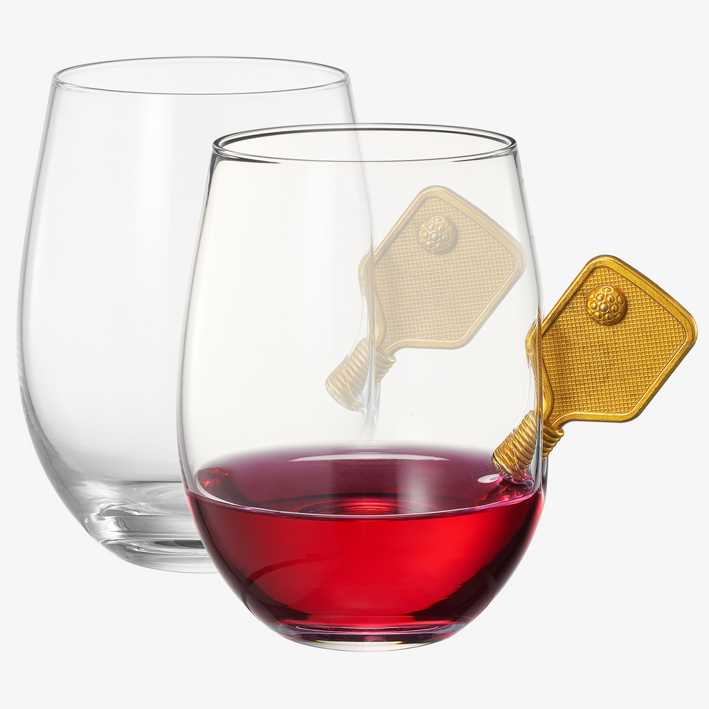 Two pickleball stemless wine glasses with decorative 3D gold racket details on a plain background