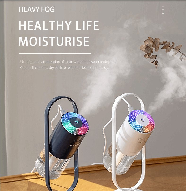 Sleek polymer mist portable air humidifier and purifier emitting fine moisture on a desk