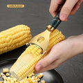 Premium stainless steel corn peeler with serrated blade edge removing fresh kernels from the cob