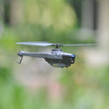 Mini RC helicopter with camera in grey plastic, featuring four propellers and flybarless design.