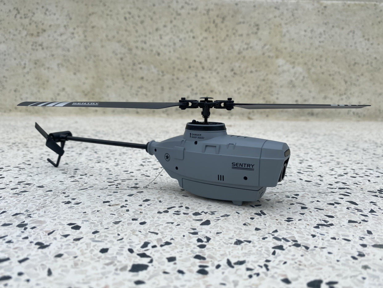 Mini RC helicopter with camera in grey plastic, featuring four propellers and flybarless design. — view 3