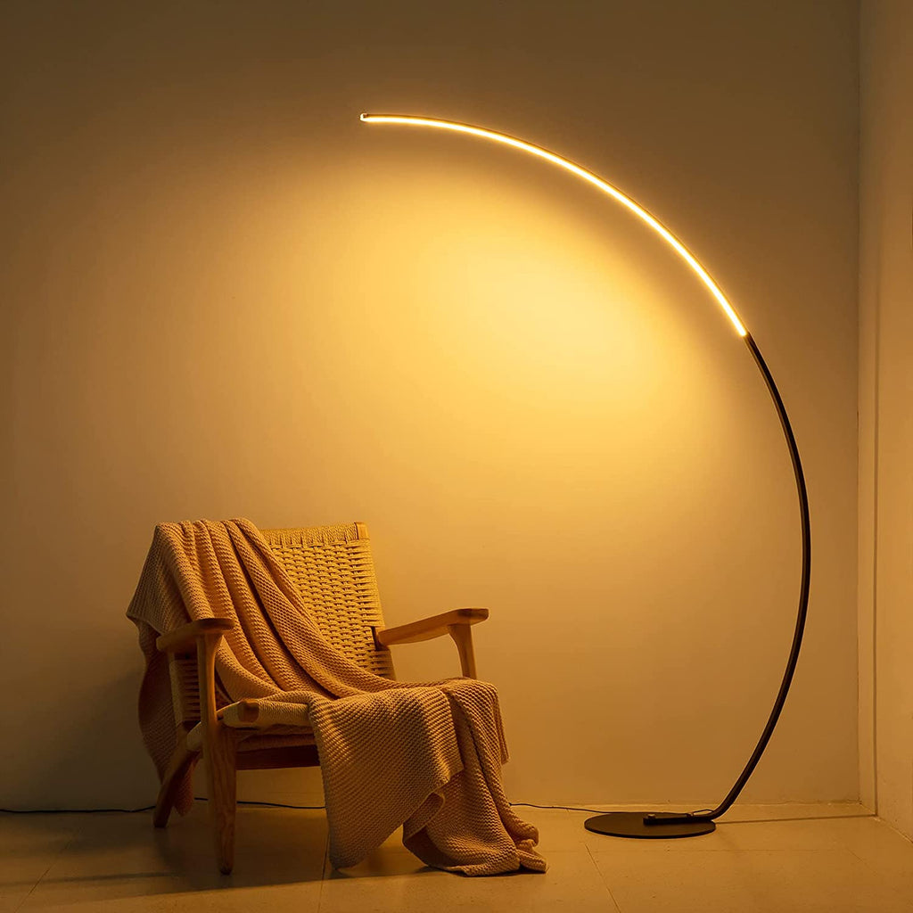 Modern RGBW curved floor lamp with metal arc emitting vibrant color changing light in living room