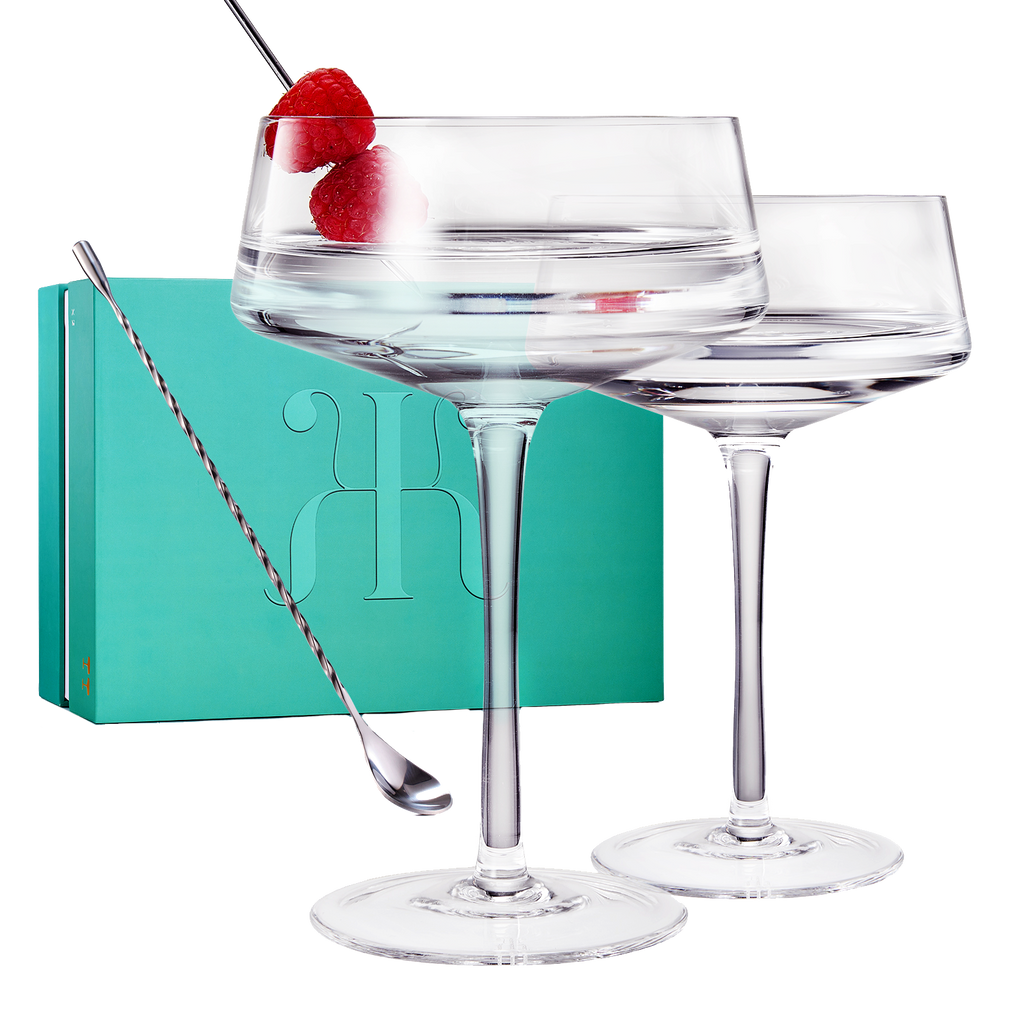 Two luxury clear glass 10oz martini coupes with an elegant silver mixing spoon for home bars