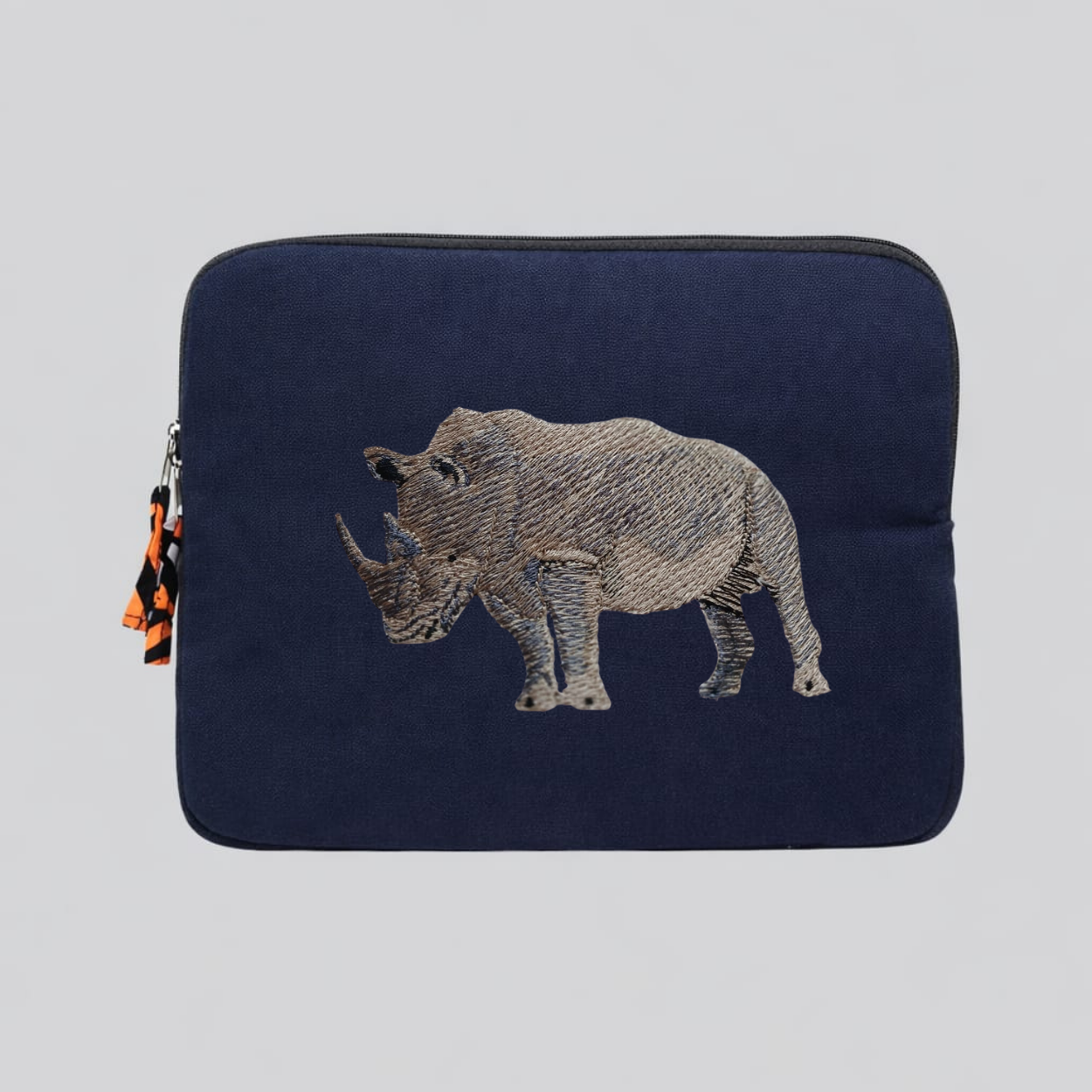Rhino laptop sleeve made of Kenyan cotton canvas with animal embroidery in warm earthy colors — view 2