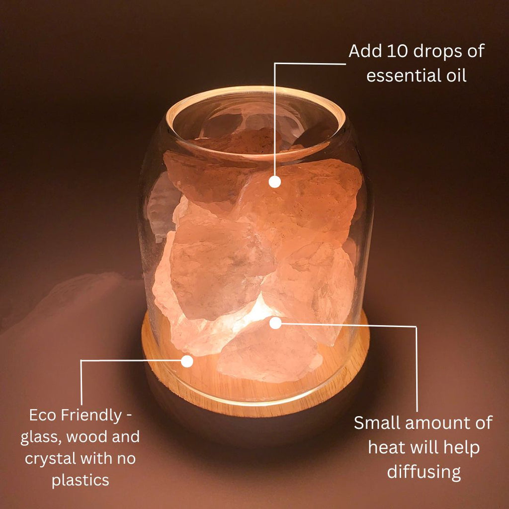 AURORA natural quartz crystal essential oil diffuser with wooden base and glass reservoir illuminated. — view 5