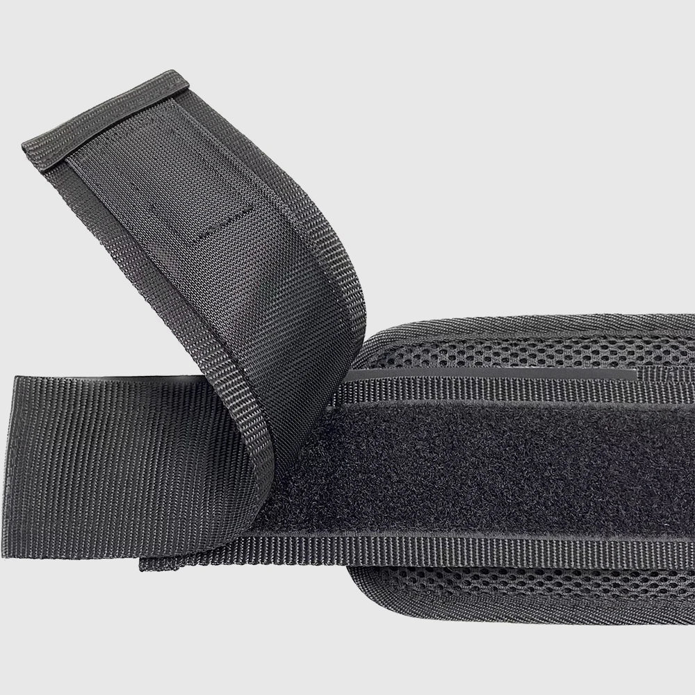 Black hip thrust belt with built-in padded cushion holding dumbbells for home glute bridge workout — view 2