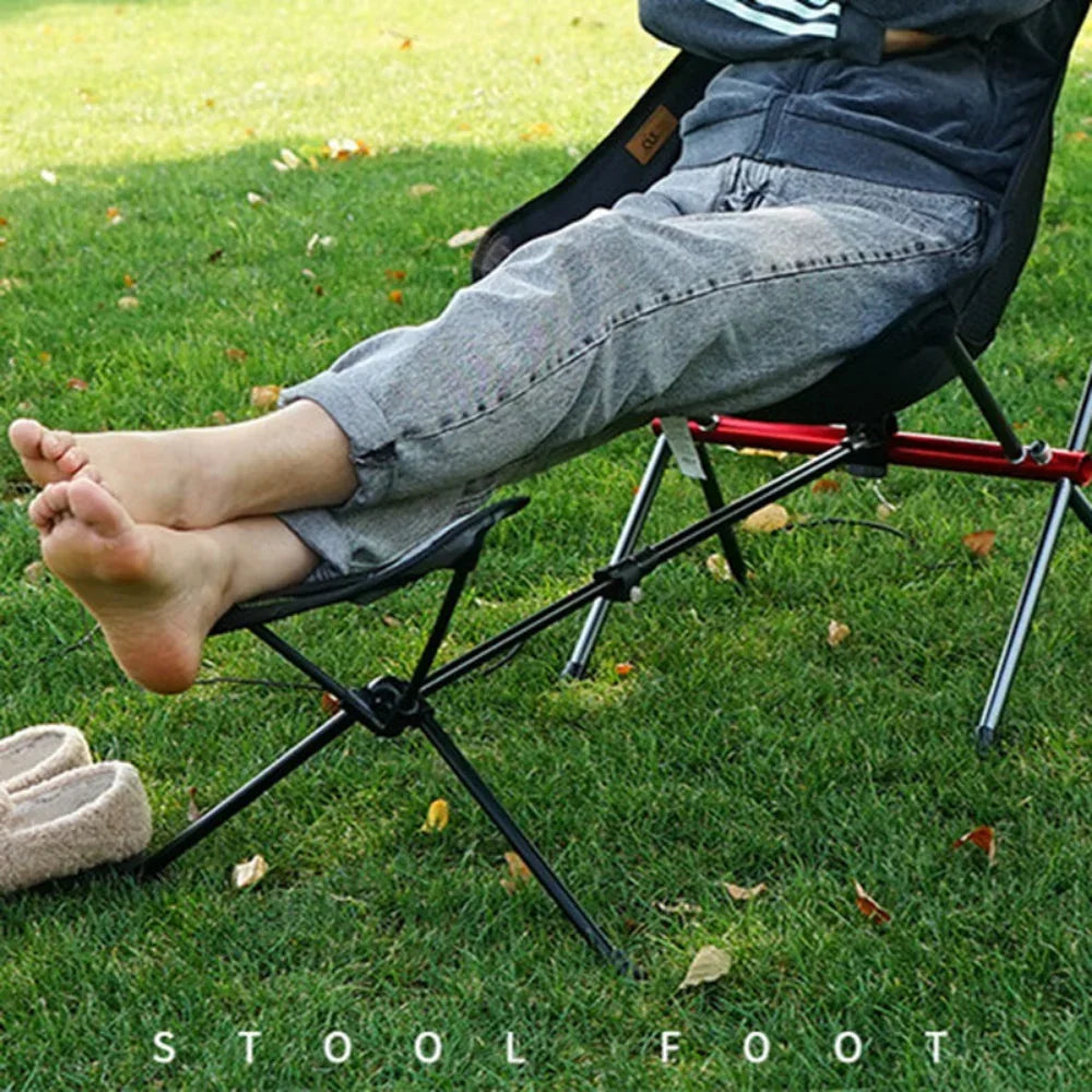 Lightweight folding outdoor camping chair with foot recliner and aluminum frame in outdoor setting — view 3