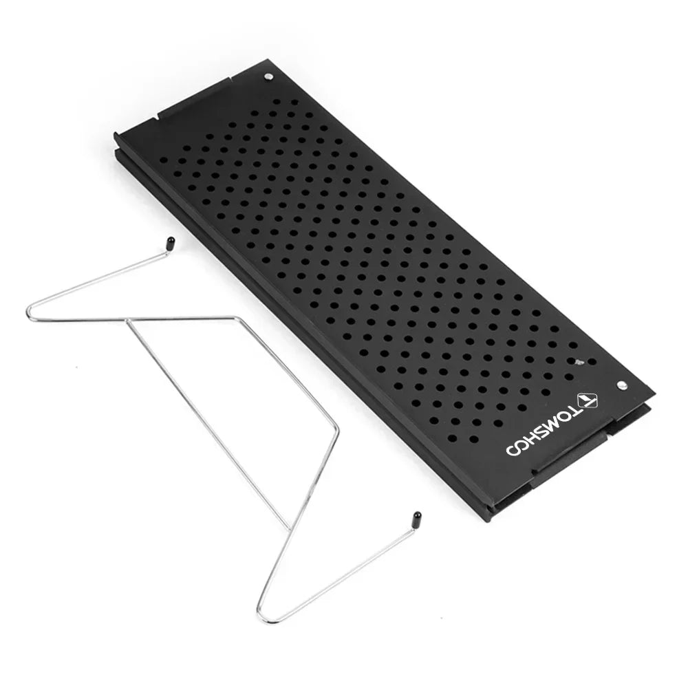 Compact metal folding camping table set up outdoors on green grass for a picnic — view 4