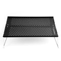 Compact metal folding camping table set up outdoors on green grass for a picnic