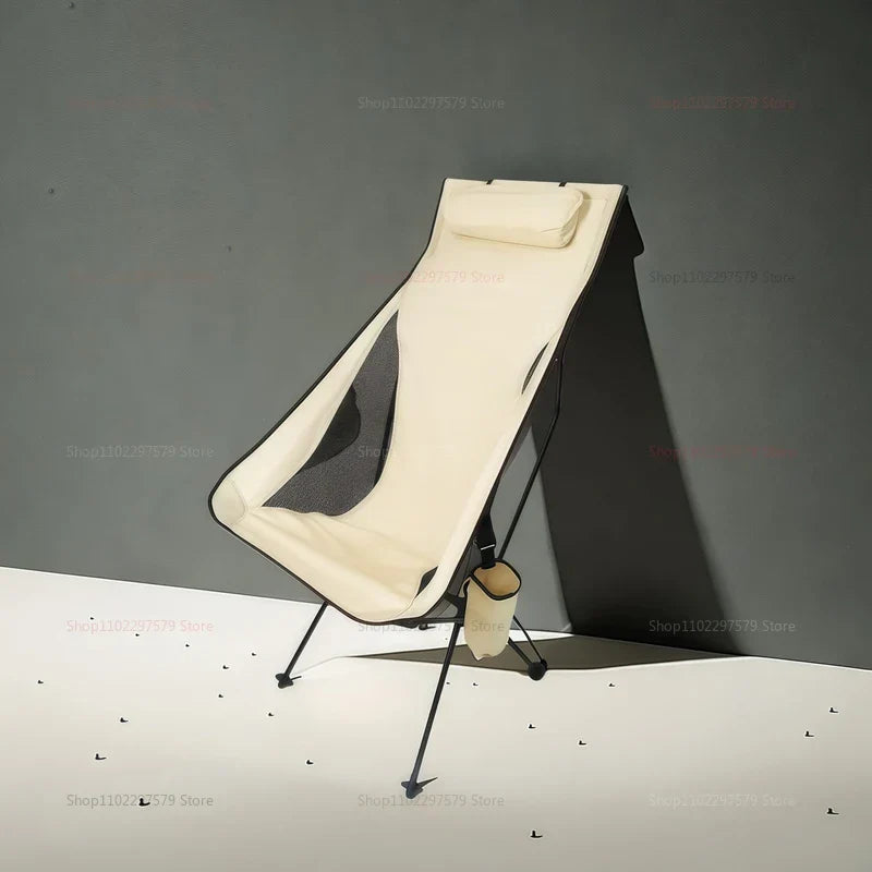 Beige portable folding camping chair with aluminum frame and ergonomic headrest on white background — view 4