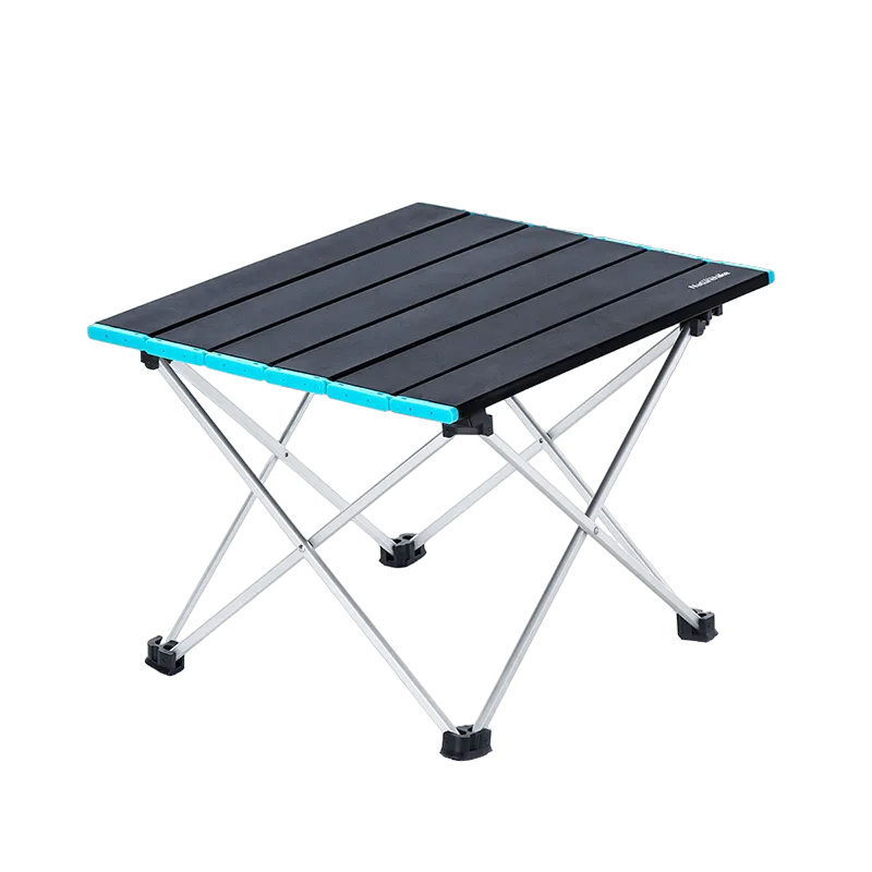 Ultralight folding camping table set up outdoors on grass for backpacking and wilderness cooking