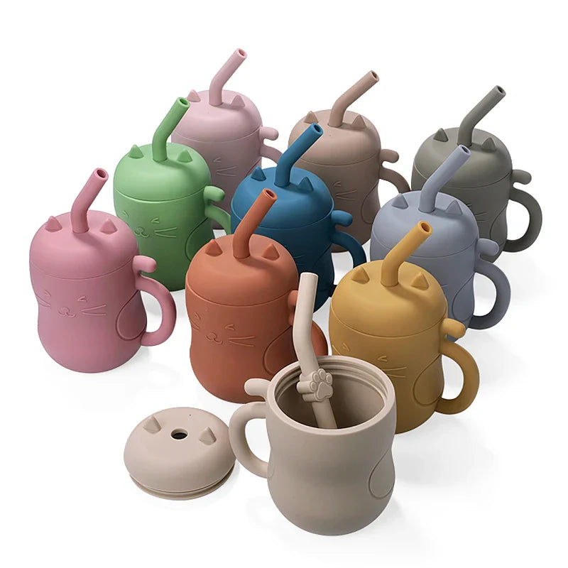 Silicone straw water bottle for toddlers featuring an embossed cat face and curled tail handle. — view 2