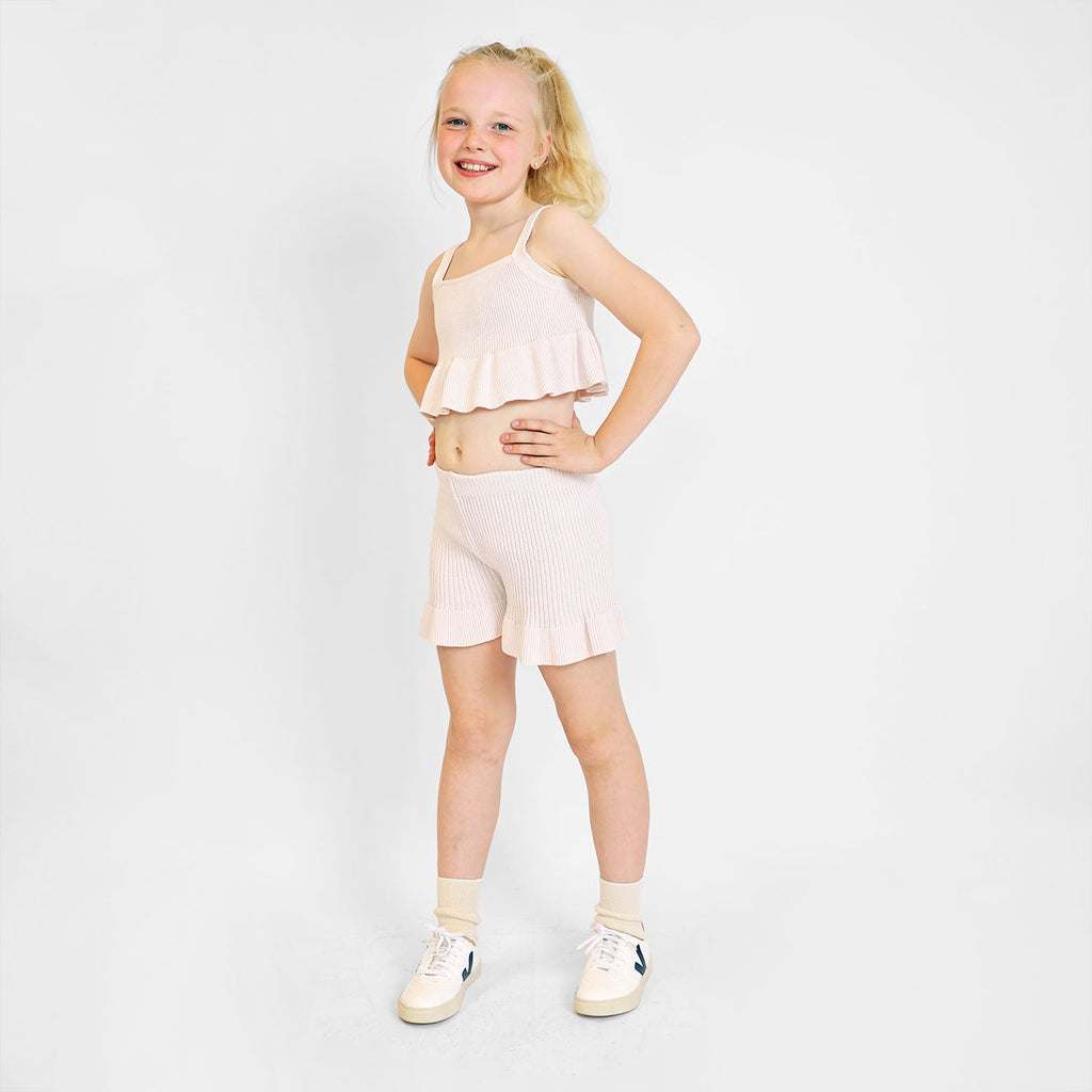 Pink crop top for girls in organic cotton knit with playful ruffled hem — view 2