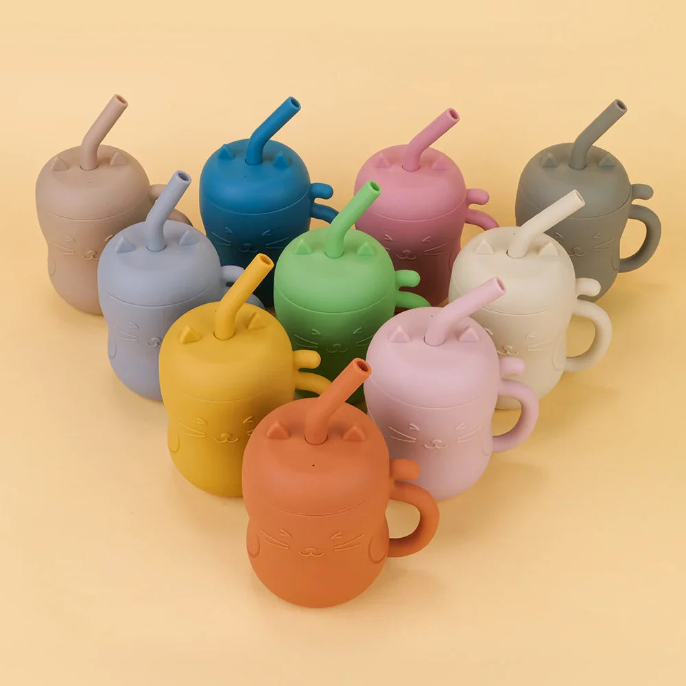 Silicone straw water bottle for toddlers featuring an embossed cat face and curled tail handle. — view 3